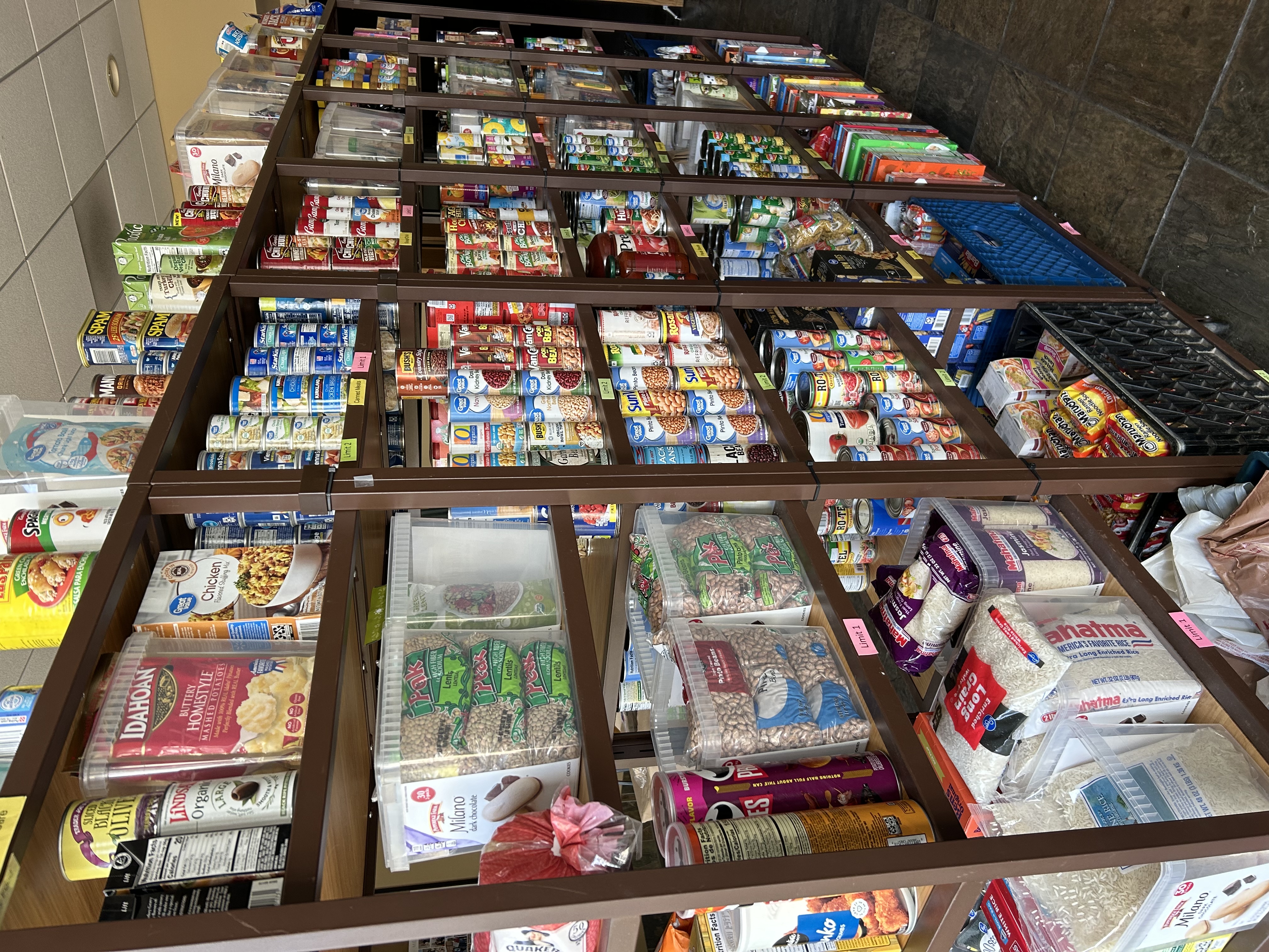 Pantry shelves filled with canned goods, rice and staples