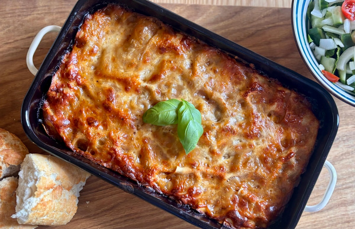 Fresh homemade lasagna with melted cheese and basil